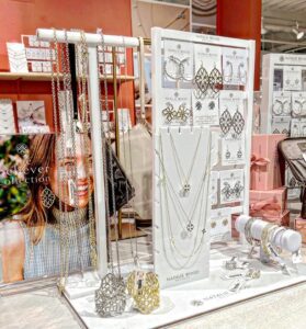 Minimalist white acrylic jewelry display set with luxury gold edges for necklace and earring presentation.