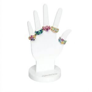 White acrylic hand-shaped ring display stand with a 5x8 inch base and custom brand logo
