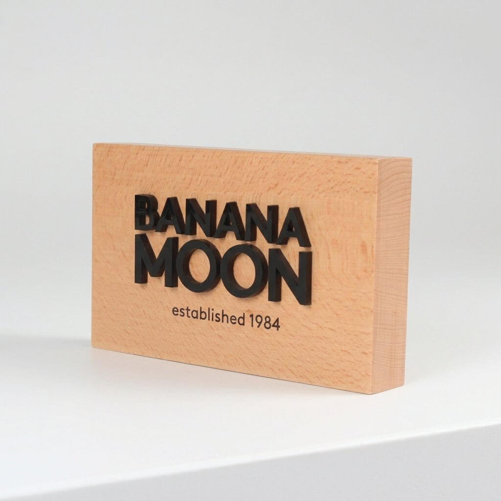 Custom 3D engraved beech wood block sign, 10x5x1 inch, featuring a branded logo for premium tabletop display.