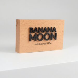 Natural beech wood table sign with custom 3D engraved logo for retail counter and office branding, 10x5x1 inch.