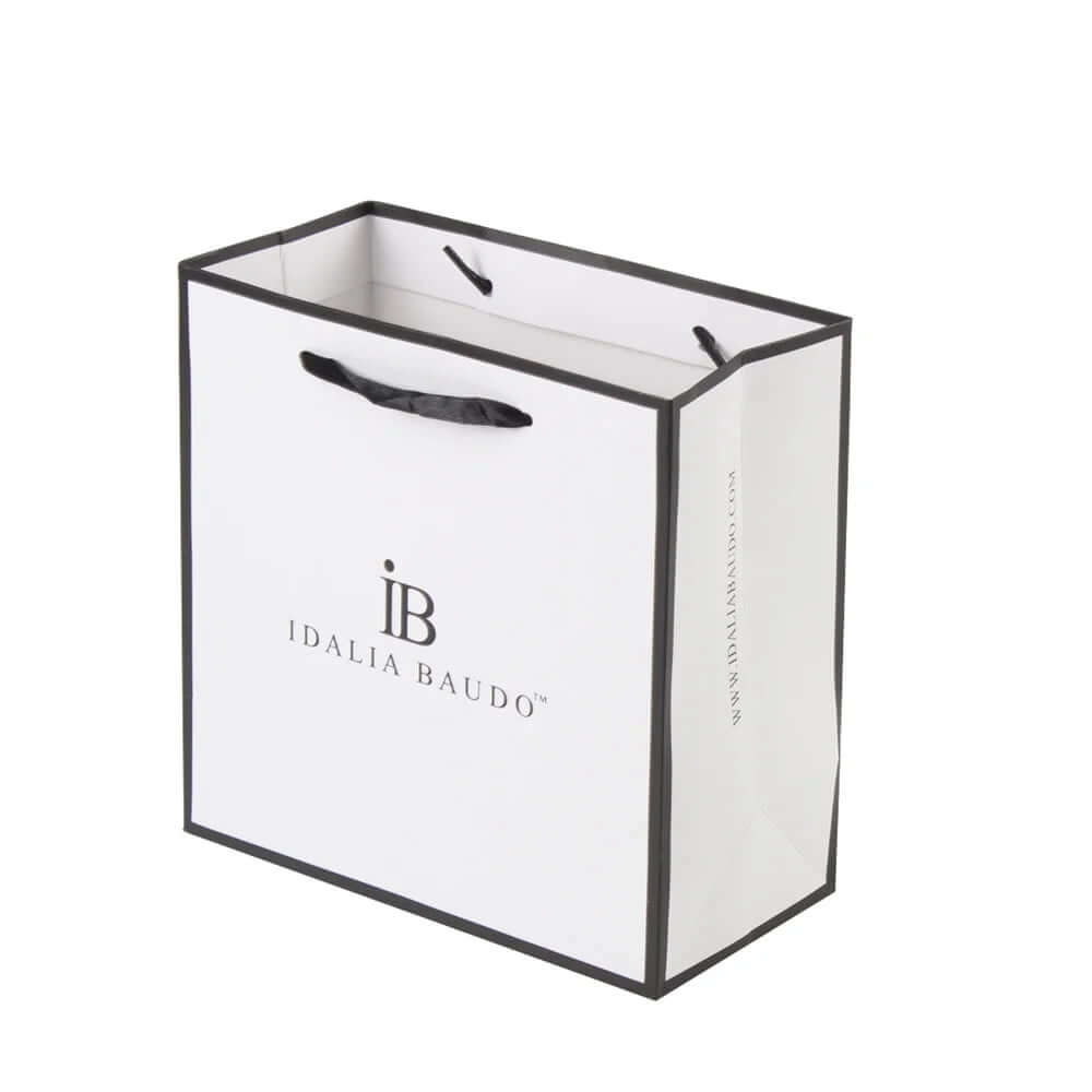 White coated paper custom jewelry paper bag with debossed black logo, black border, and ribbon handles.