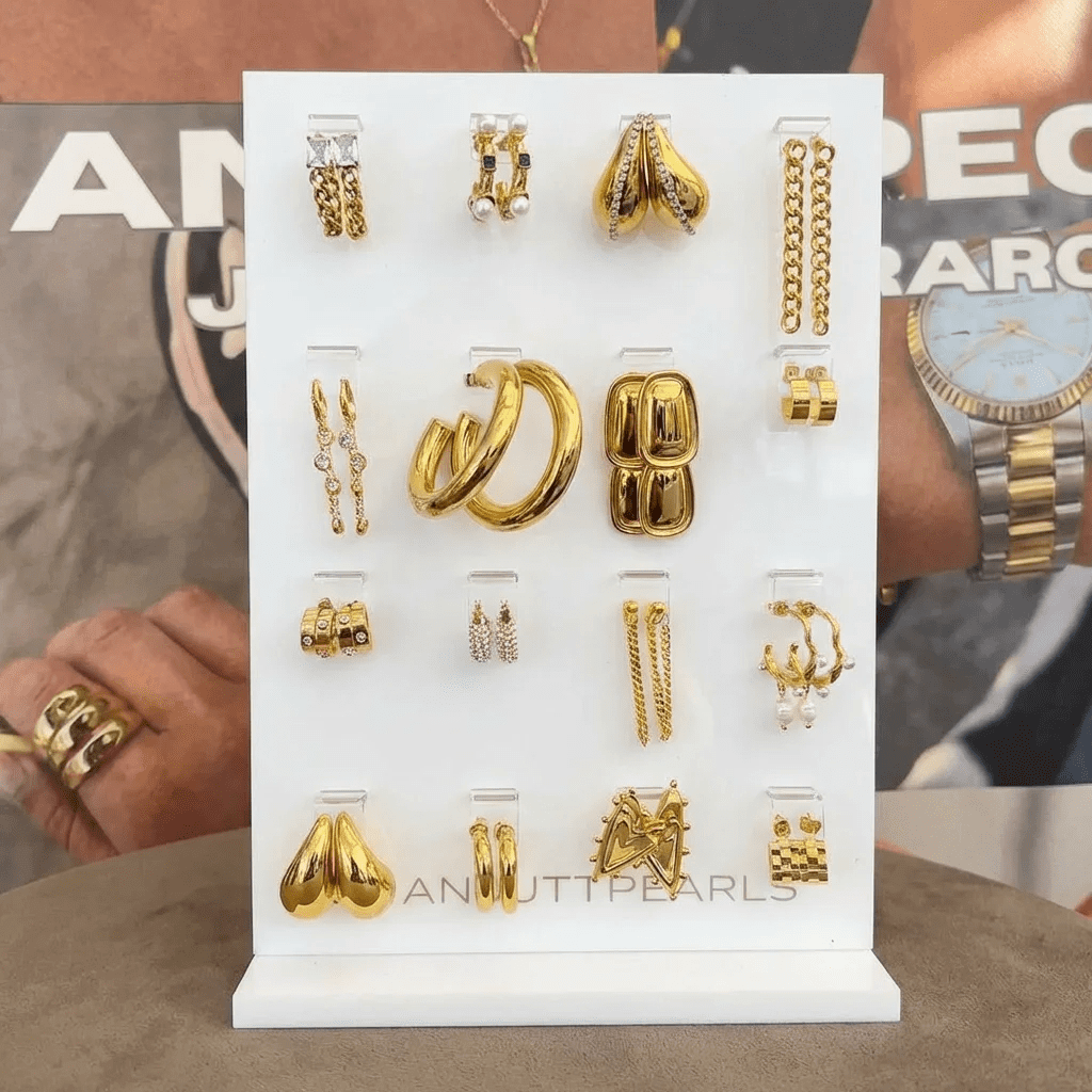 Double-sided white acrylic earring display stand with transparent hanging holes for 32 pairs of studs and drops.