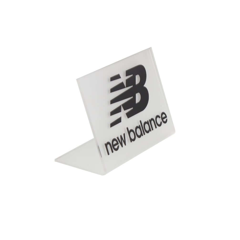 Frosted acrylic tabletop L-shaped logo display sign with custom silk-screen printing for retail branding.