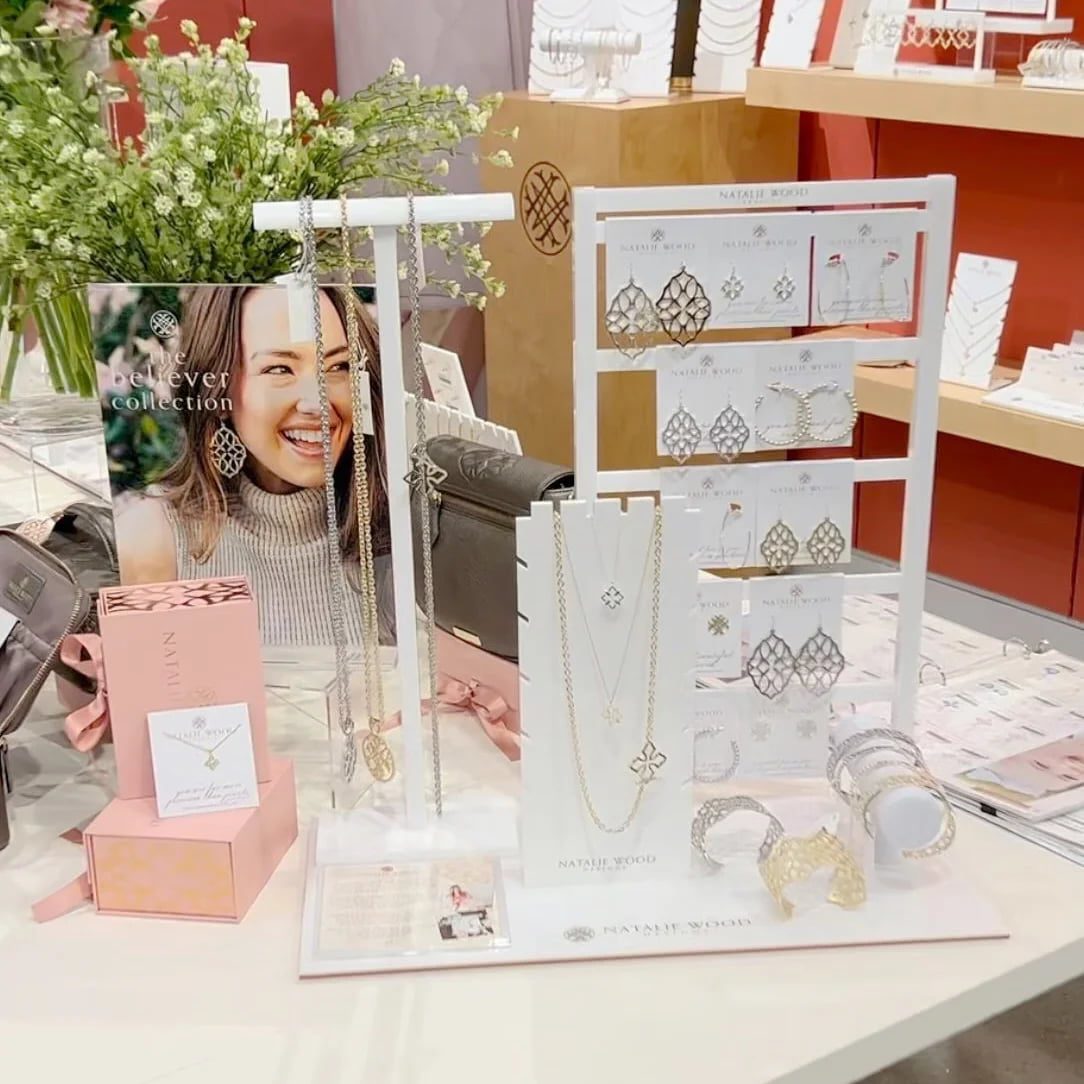 Professional white acrylic jewellery display set featuring elegant gold trim for boutique necklace and earring card branding.