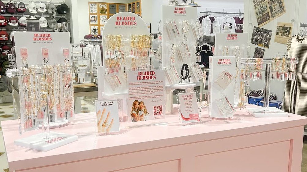 A complete collection of white and clear acrylic jewelry display stands including T-bars, ring slots, and earring trees for a cohesive showcase.