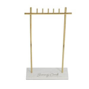 T-bar gold necklace display stand with heavy white marble base for long pendant organization.