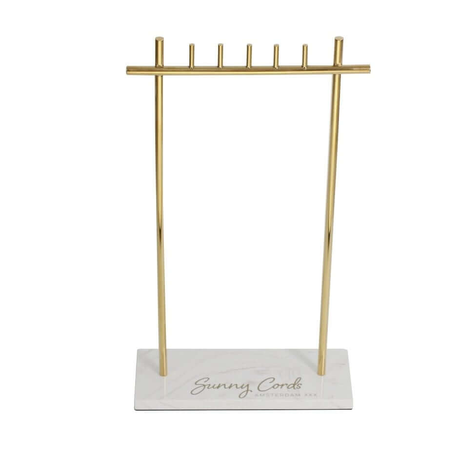 T-bar gold necklace display stand with heavy white marble base for long pendant organization.