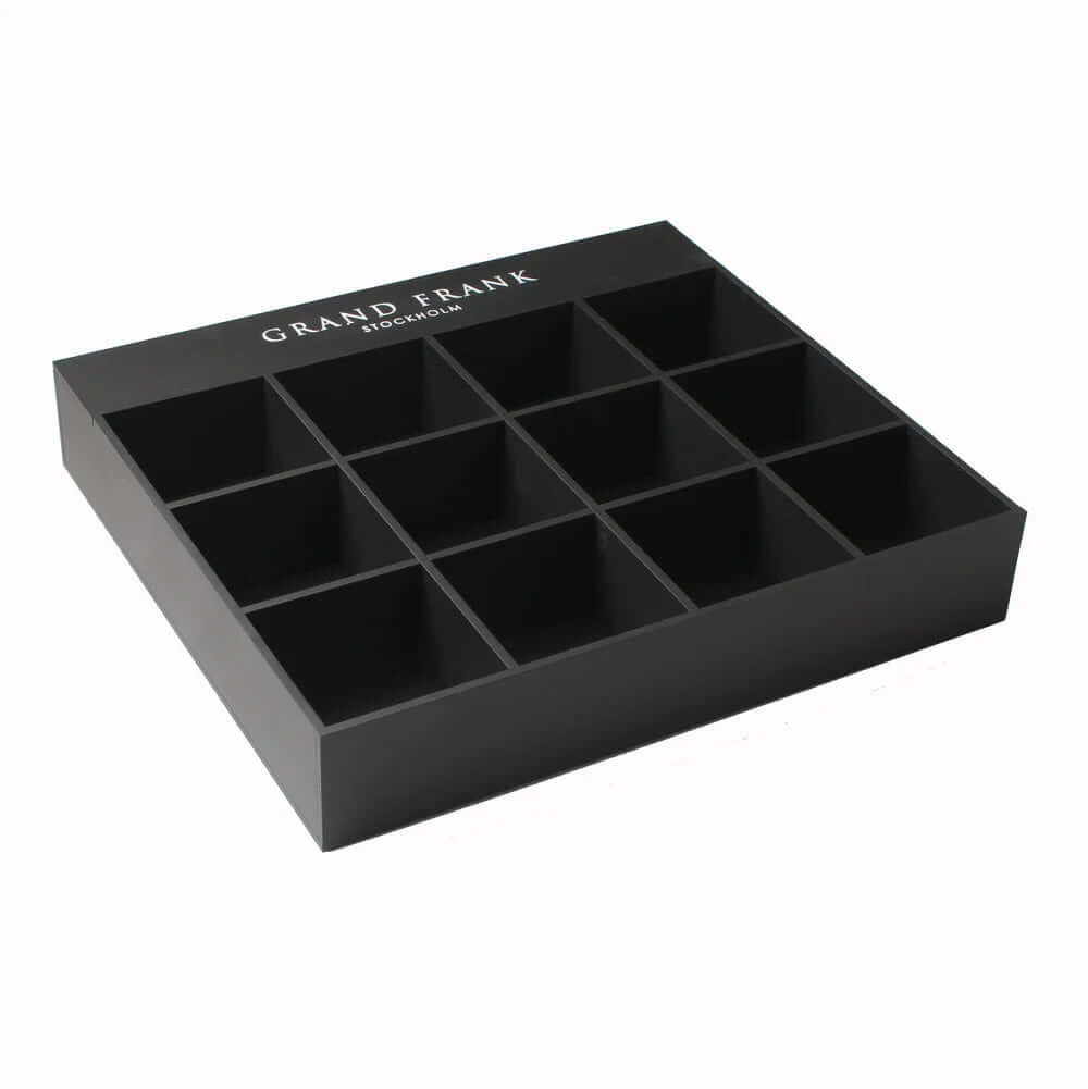 Matte black acrylic 12-slot jewelry display box with customizable logo inserts for rings and watches.