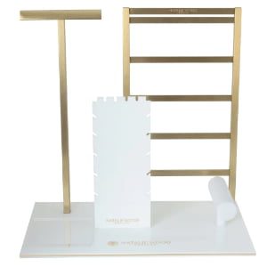 White acrylic jewelry display set with gold trim and custom logo for necklaces and earring cards.