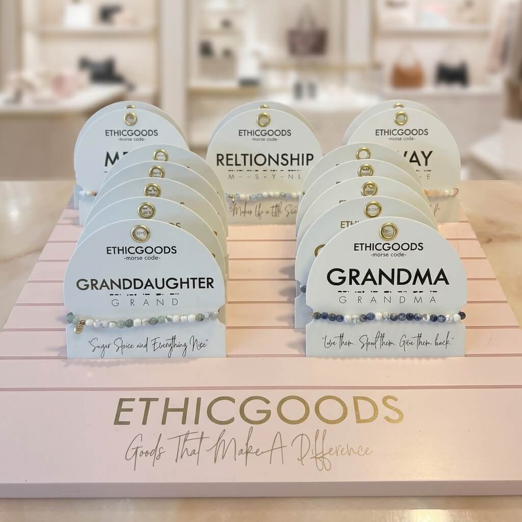 Pink acrylic bracelet card stand with 11 deep slots and custom gold foil logo for showcasing jewelry cards.