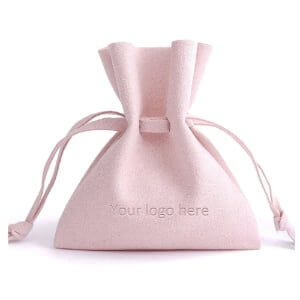 Soft pink microfiber drawstring jewelry pouch with debossed custom logo for rings and necklaces, size 3.15x4.7 inches